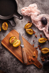 Fresh raw plums ready to be prepared on cutting board