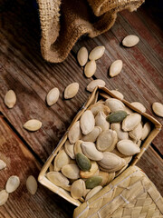 Pumpkin seeds in a box on a wooden table