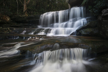 Fototapeta premium tiers of falling water at somersby falls on nsw central coast