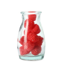 Delicious gummy raspberry candies in glass bottle on white background