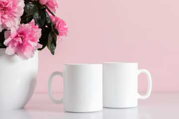 Two mugs mockup, pot with pink flowers on pink background.