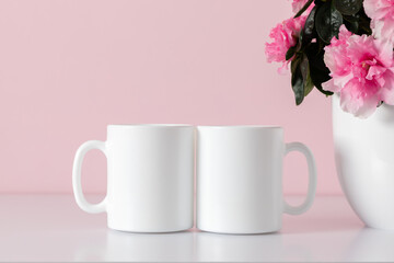 Two mugs mockup, pot with pink flowers on pink background.
