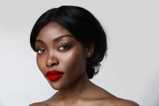 Portrait of black African beautiful young woman with make-up. Isolated. Close-up
