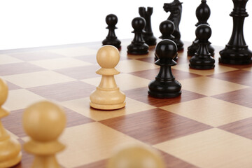 Chess pieces on wooden board against white background