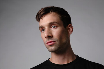 Obraz premium Portrait of young handsome man with serious face expression. White background.