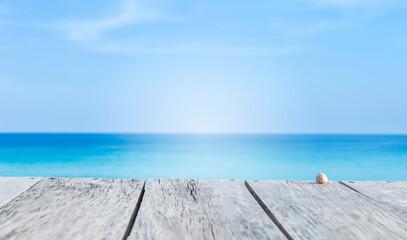 Wooden floor over blurred beach background, summer season, outdoor day light
