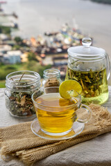 Refreshing and enjoy with A cup of lemongrass pandan tea served with brown sugar In the afternoon on beautiful river view. Thai herbal plant and healthy drinks concept. Selective focus, Copy space.