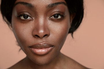Close-up portrait of black African beautiful young woman with make-up. Isolated.