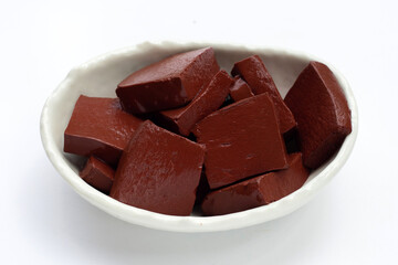 Pork blood pudding in white bowl on white background.