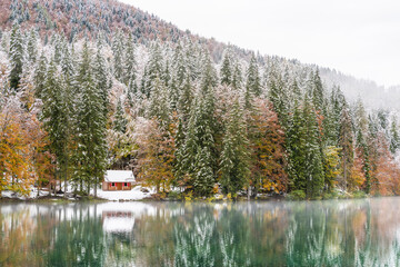 Between autumn and winter. Warm and cold reflections of snow on Lake Fusine.