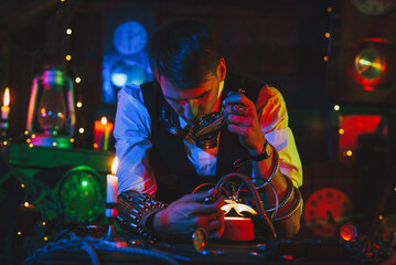 male inventor in a steampunk suit repairs the mechanism. A watchmaker with tools and a magnifying...