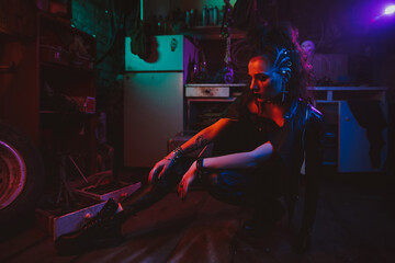Cyberpunk girl in a steampunk costume in a garage with neon lighting