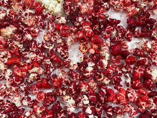 Red popcorn on white table