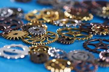 high angle wheel group of cog gear wheels against blue background