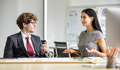 Beautiful secretary enjoy negotiating creative happy idea to corporate caucasian manager for proposal report to succeed business marketing planning on computer screen on office desk in company