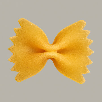 Close up uncooked farfalle bowtie pasta on gray background
