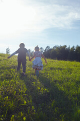 Fototapeta na wymiar cute kids are walking in fields