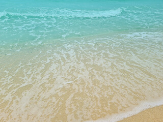 Soft blue waves on a clean sandy beach. travel photos