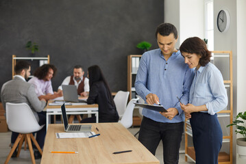 Young people working with documents or report notes. Portrait of two business professionals and...