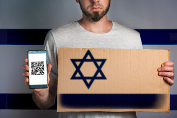A man with a cardboard and a phone in his hand. The Flag Of Israel. Concept of freedoms and human...