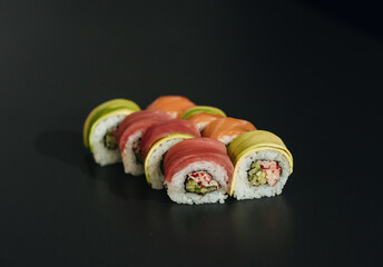 Rainbow Sushi Roll with salmon, eel, tuna, avocado, king prawn, Philadelphia cream cheese, tobiko caviar, chuka. Sushi menu. Japanese food.