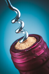 Wine bottle and wine opener on blue