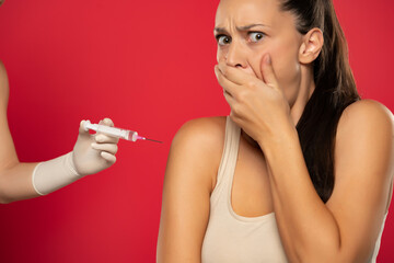 a young woman is afraid to be vaccinated