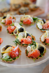 tartlets appetizers with salmon on big white plate
