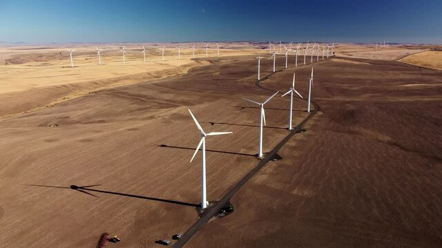 Desert Wind Turbine with Moon in distance