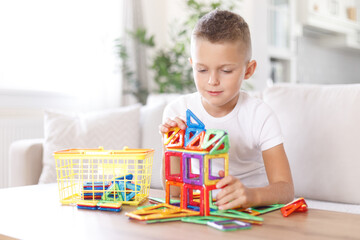 Handsome boy playing with constructor, happy child, little kid play with toys at home