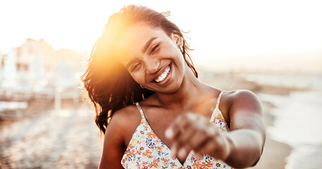 Portrait of a young black woman having fun at beach party - Happy female enjoying sunset by the sea...