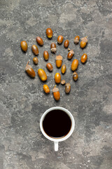 Many ripe accents fly in a white cup with an alternative drink without caffeine on a gray background