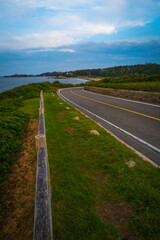 Moody coastal road with dramatic clouds on Cape Cod in the summer