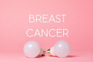 Breast Cancer Awareness Month. Two electric light bulbs on a pink background. Close up. The concept...