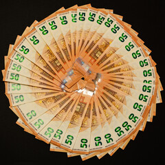 winning the lottery, euro on a black background, texture of money.