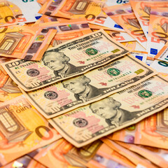 Texture of money from dollars and euros, ten dollars and fifty euros.