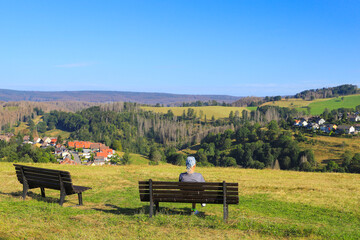 A man is watching to Sankt Andreasberg, Harz mountains - Germany
