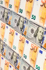 Dollars and euros, confrontation and domination, influence, world currencies close up.