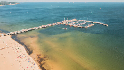 Sopot,Poland,Europe. Beautiful panoramic aerial photo from drone to Wooden pier (molo) with promenade  marina, yachts,  beach, Sopot.(Series) - obrazy, fototapety, plakaty