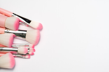 Set of professional, natural makeup brushes. Luxury pink make up brushes in silver and pink colours on a white background