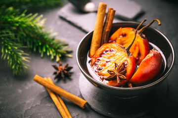 Christmas dessert - flamed tamarillo in hot wine punch with cinnamon and anise