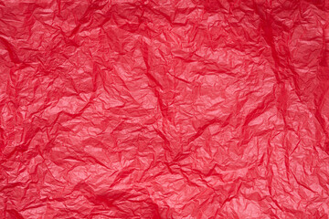 Red crumpled paper or sheet texture background for Design. Wallpaper for text. Copy space.
