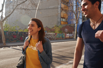 Young friends smiling as they walk