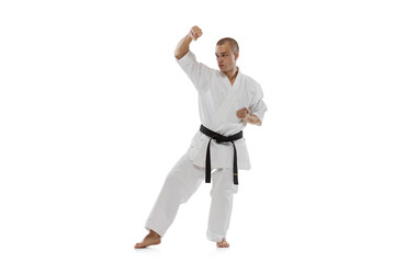 Cropped portrait of young sportsman training karate isolated over white background. Karate, judo,...