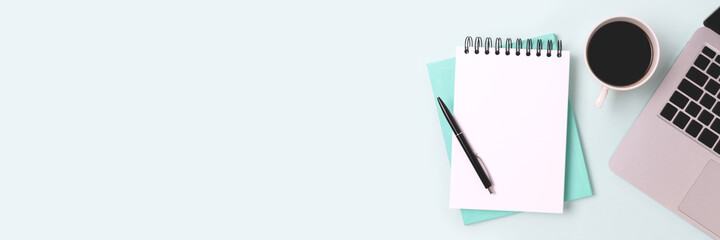 Banner with laptop and open notepad on a blue background. Workspace for online education with copy space.