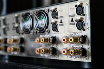 rear panel of the stereo amplifier. Audio electronics, connectors for cable connections. Mode switch. listen to good music, beautiful sound. Shallow depth of field, bokeh. Fan grill.
