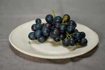 Belgian grapes on a white plate, still life