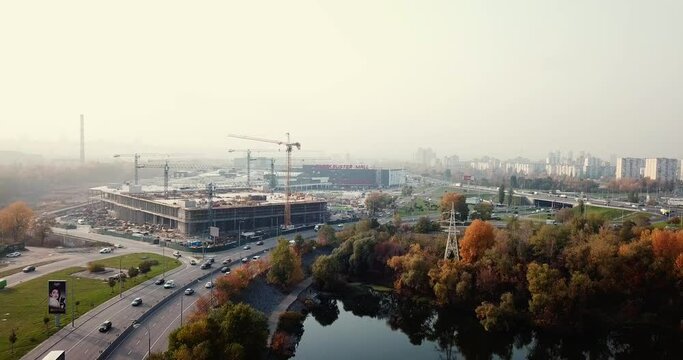 Flight over the highway, along the river and the industrial zone on the other side against the background of a railway bridge autumn, Kiev Ukraine.