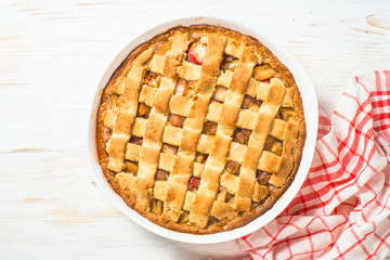 Apple pie with ginger and cinnamon at white wooden table. Top view. Traditional american baking.