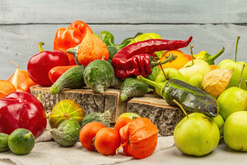 Trendy ugly organic vegetables and fruits on stone concrete background